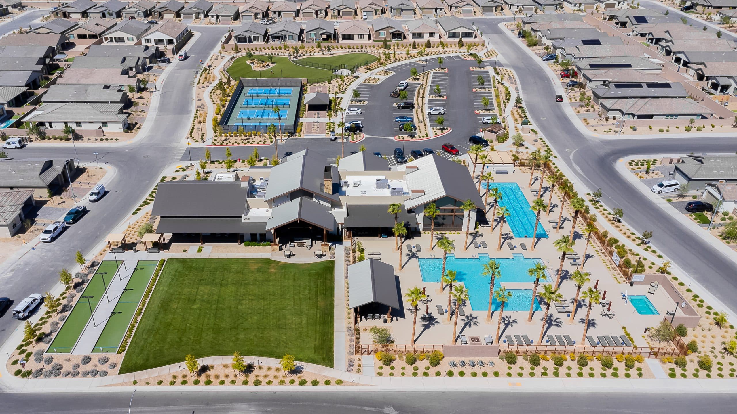Overhead of Del Webb North Ranch clubhouse, pools, pickleball, bocce, and single-story homes in North Las Vegas